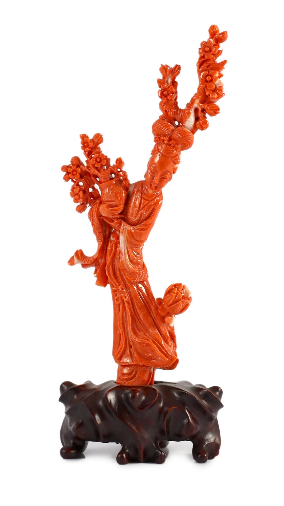 A Chinese carved coral figure of a flower fairy, 20th century, the carving 19cm high and 119g, wood stand